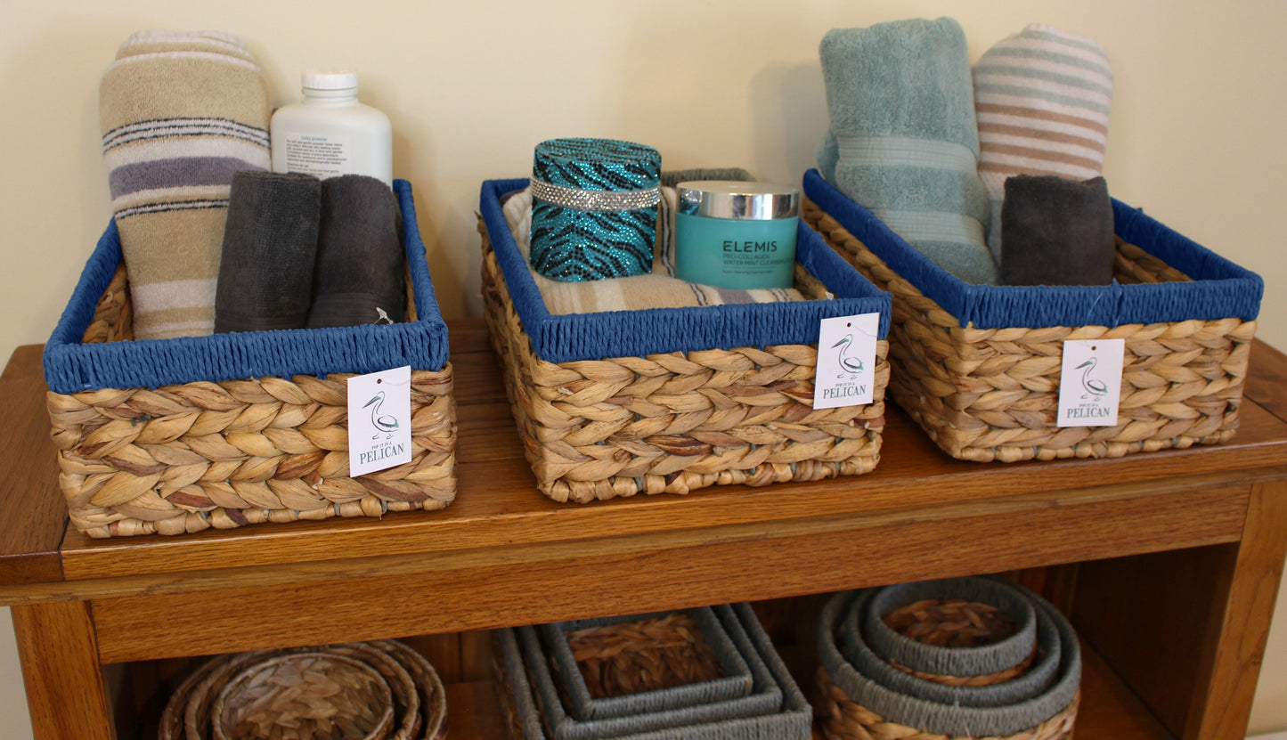 Small water hyacinth rectangular baskets with blue edges.