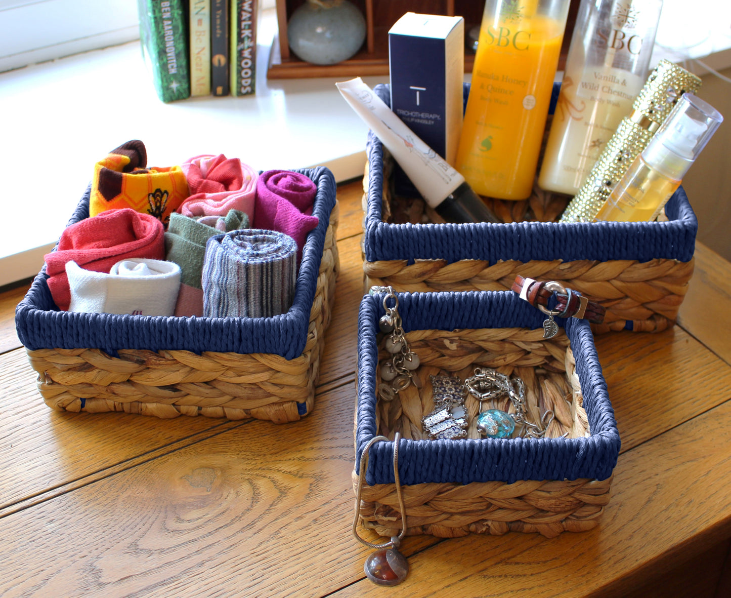 Small water hyacinth square baskets with blue edges.
