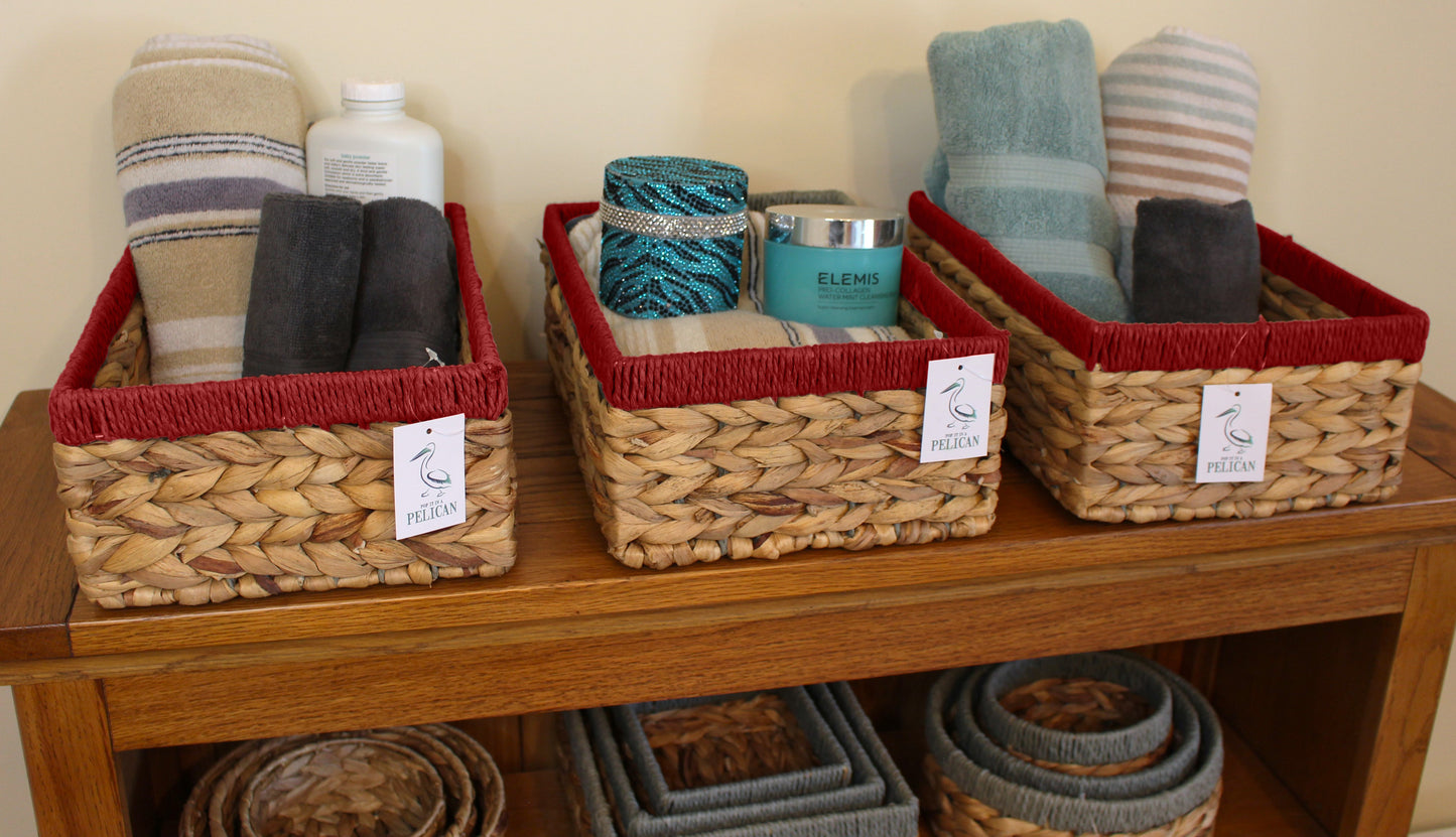 Small water hyacinth rectangular baskets with red edges.