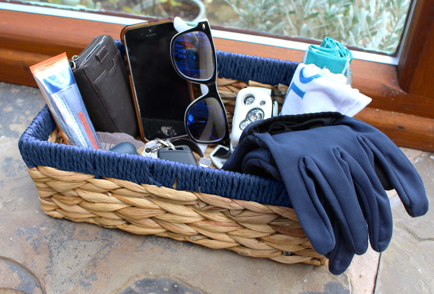 Small water hyacinth rectangular baskets with blue edges.