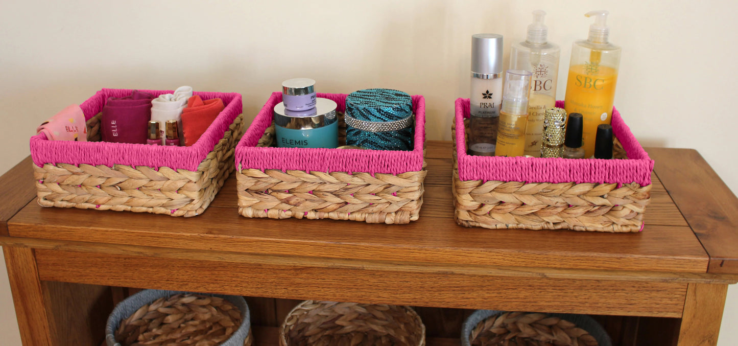 Small water hyacinth square baskets with pink edges.