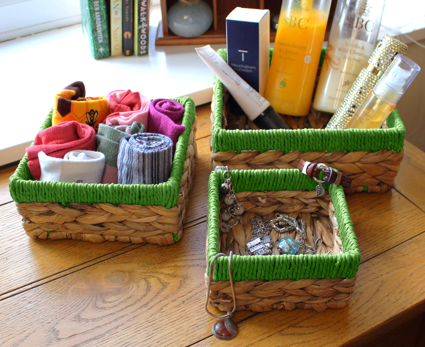 Small water hyacinth square baskets with green edges.